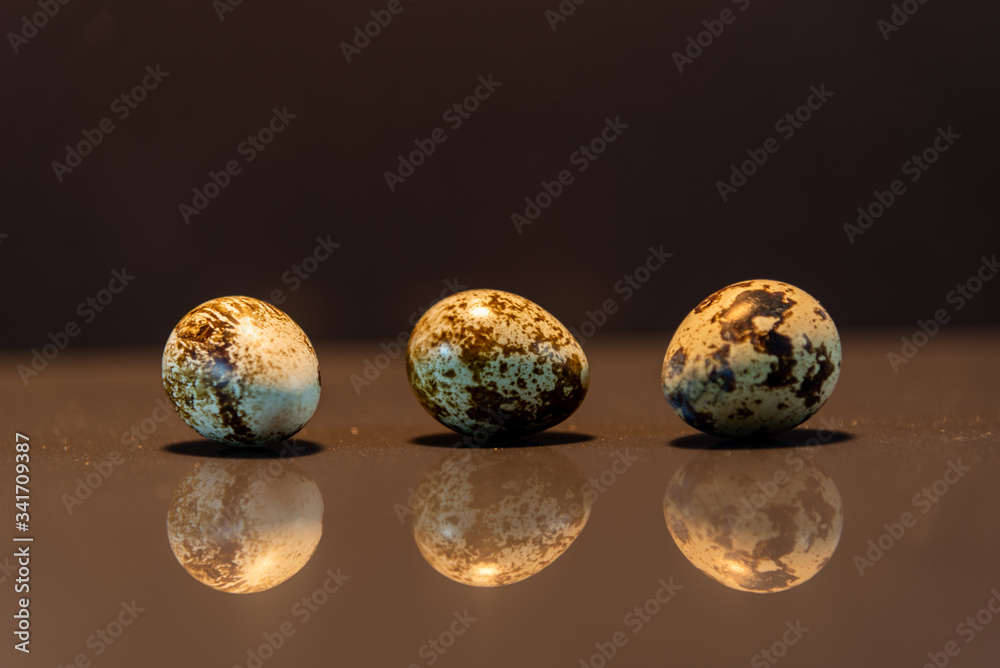 Fresh quail eggs on mirrored background Fresh quail eggs on mirrored background
