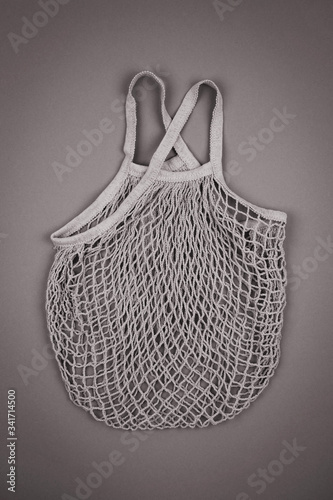 Top view of empty reusable string mesh eco bag for shopping in black and white color. Zero waste and plastic free concept. Sustainable lifestyle.