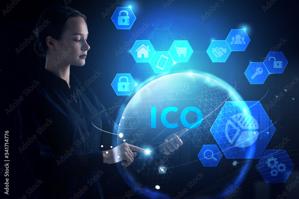 © Egor - Business, Technology, Internet and network concept. Young businessman working on a virtual screen of the future and sees the inscription: ICO
