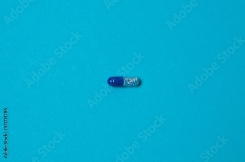Pill on a blue background, isolate, with place for text.
