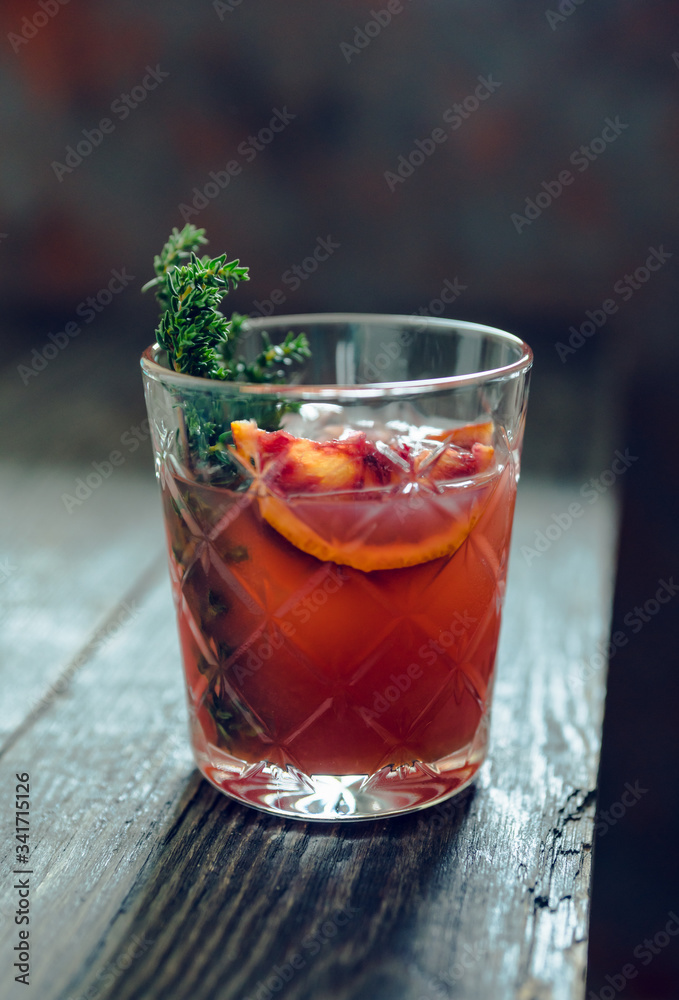 Old-0fashioned cocktail with blood oranges and thyme on the rustic background. Selective focus. Shallow depth of field. Old-0fashioned cocktail with blood oranges and thyme on the rustic background. Selective focus. Shallow depth of field.