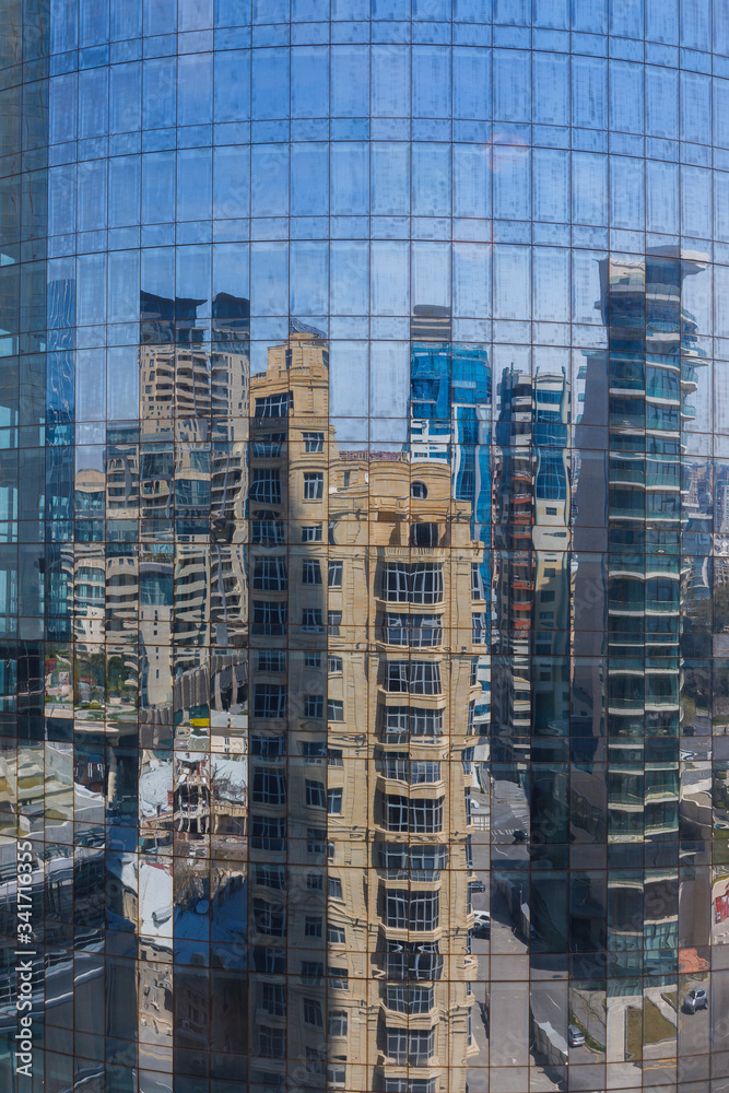 Reflection of buildings in the glass of a high-rise building