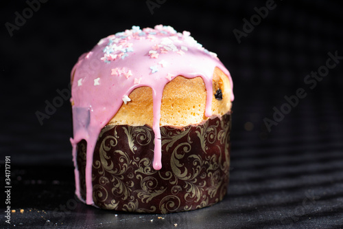 Easter cakes with dessert decoration. On the table, dark background. photo