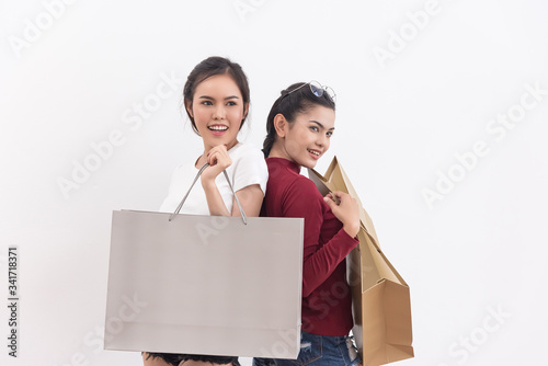 Happy asian shopping woman hold shopping bags in hand enjoy in lifestyle shopping concept, in midnight sales and discount on seales. photo