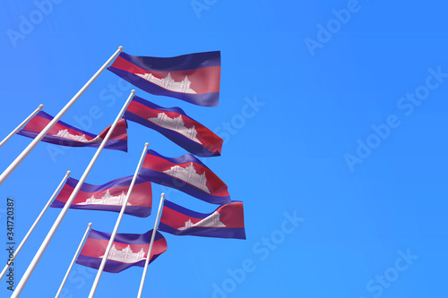 Cambodia flags waving in the wind against a blue sky. 3D Rendering