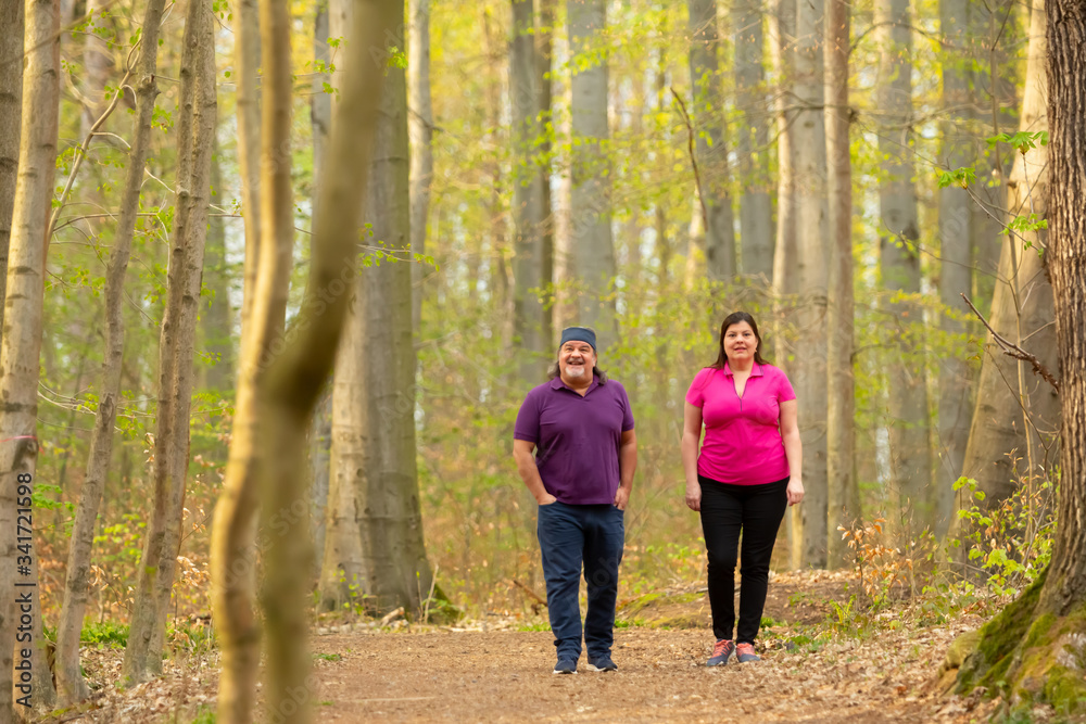 Couple Walking together far deep in the forest. Couple Walking together far deep in the forest.