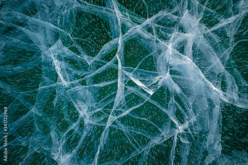 Texture of transparent ice with cracks on lake Baikal Texture of transparent ice with cracks on lake Baikal