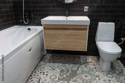 modern bathroom suite with wall mounted wc and sink unit and large mirror