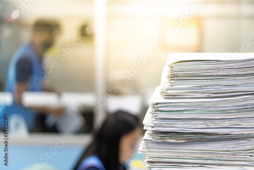 Stacks of paper files work desk office, business report papers,piles of unfinished documents achieves, Business concept.