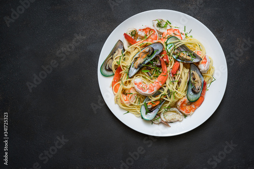 Fresh Spaghetti pasta with seafood on old kitchen table.
