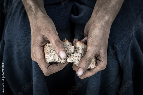 dirty women's hands with a piece of bread, poverty, hunger