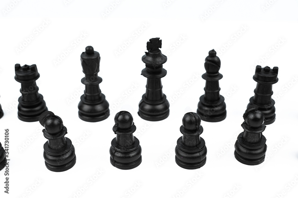 Eight different black color pawns placed on top of a white isolated background Eight different black color pawns placed on top of a white isolated background