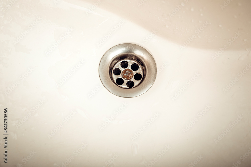 Water draining at sink background. Water flowing drain in washbasin