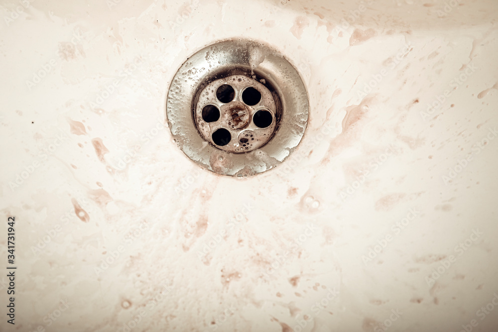 Water draining at sink background. Water flowing drain in washbasin Water draining at sink background. Water flowing drain in washbasin