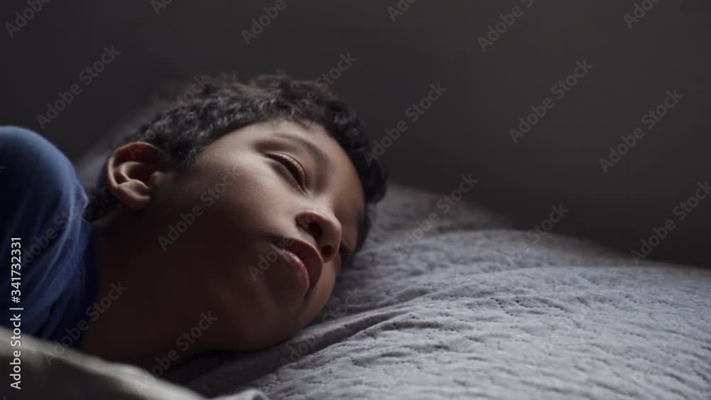 Hispanic Child Sleeping in Bed And Waking Up Early Morning