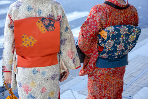 Kyoto Traveling. Geishas in Traditional Japanese Kimono and Backpacks Posing in Kyoto City,  Japan. photo