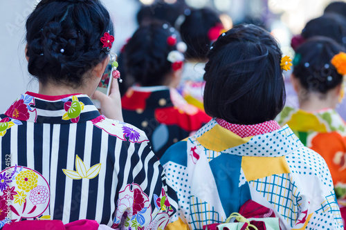 Asian Travel Destinations. Group of Female Geishas in Traditional Japanese Silk Kimono Walking on Street of Kyoto City, Japan.