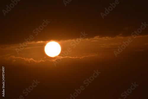 Sunrise in the summer with golden clouds.