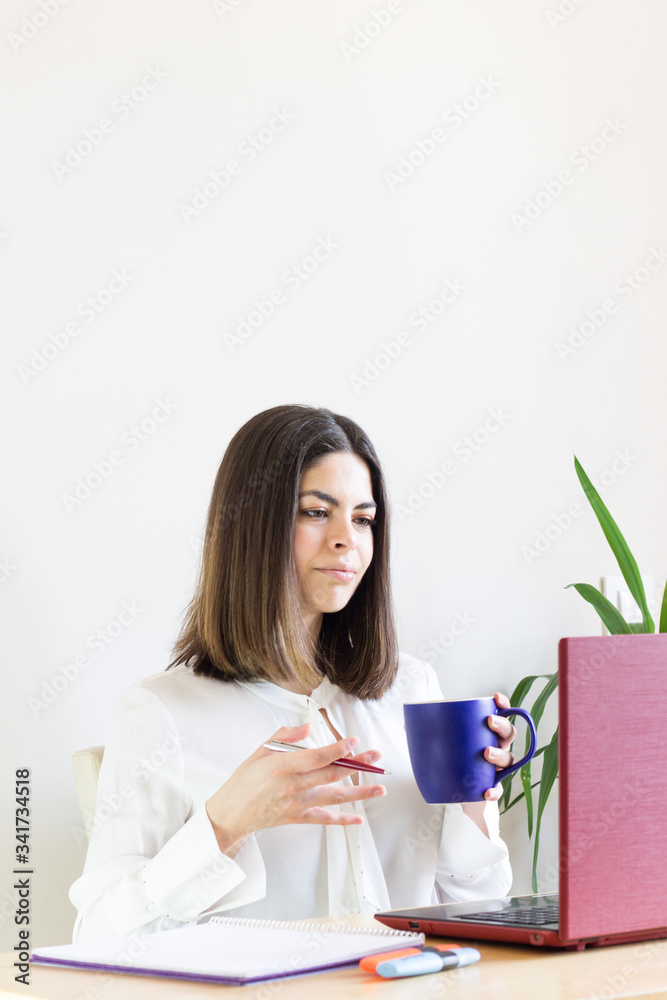 Happy casual woman teleworking from home due to Covid-19 situation. Explaining something to your employees. Happy casual woman teleworking from home due to Covid-19 situation. Explaining something to your employees.