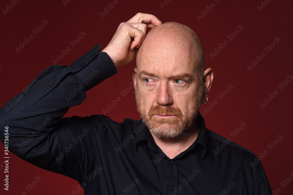 man with hand on head on red background man with hand on head on red background