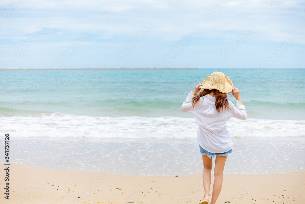 Happy young girl walking on the beach. Summer travel, vocation, holiday concept. Happy young girl walking on the beach. Summer travel, vocation, holiday concept.