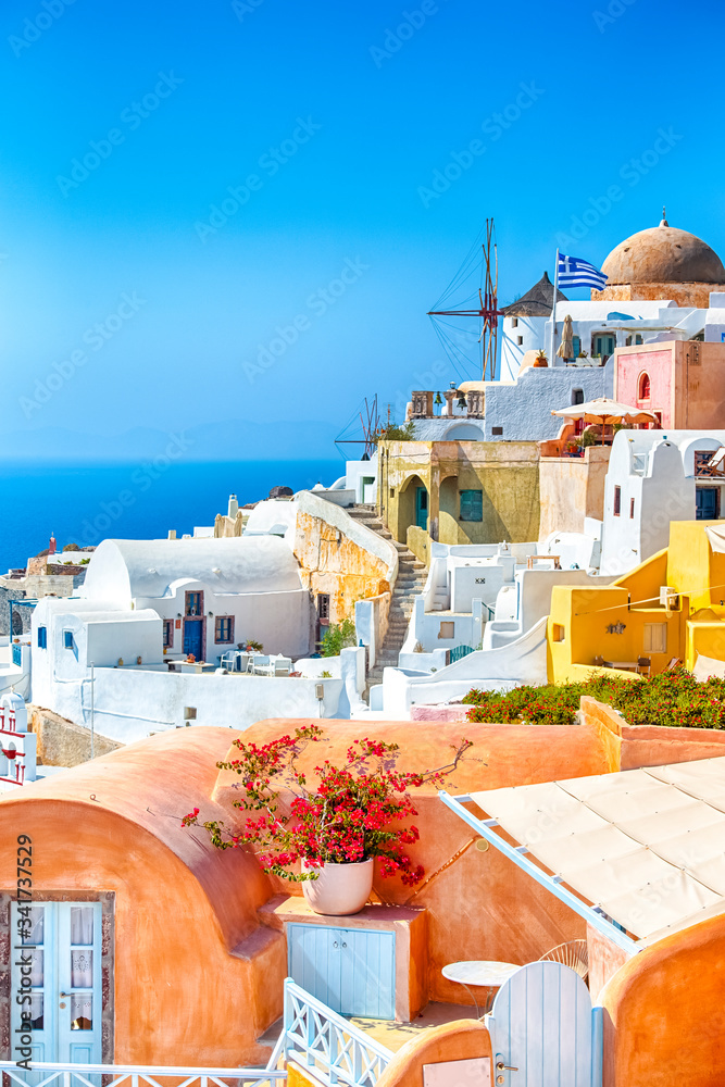 Naklejka premium Greece Traveling. View of Greek Traditional Colorful Houses and Windmills of Oia or Ia at Santorini Island in Greece at Daytime.