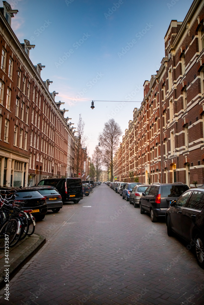 Typical Amsterdam street, white and red brick, 4 stories.