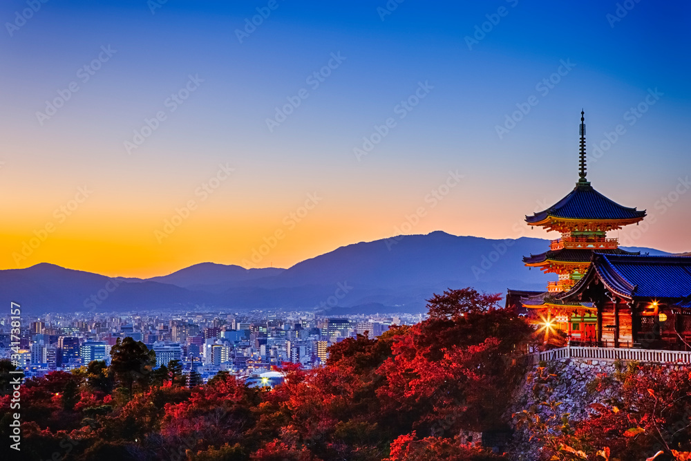 Traveling Through Japan. Amazing Vivid Sunset Over Kiyomizu-dera Temple Pagoda With Kyoto City Skyline in Background in Japan. Traveling Through Japan. Amazing Vivid Sunset Over Kiyomizu-dera Temple Pagoda With Kyoto City Skyline in Background in Japan.