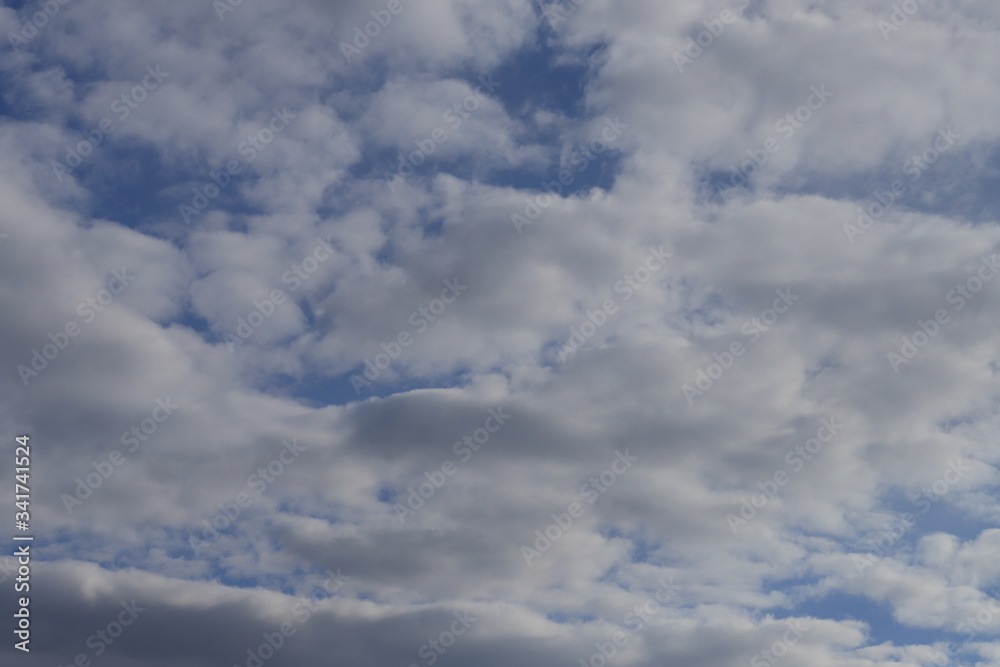 Fluffy clouds of the spring sky. Cold sky with clouds.