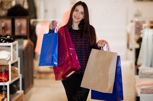 Portrait of happy smiling woman holding shopping bag. place for advertising