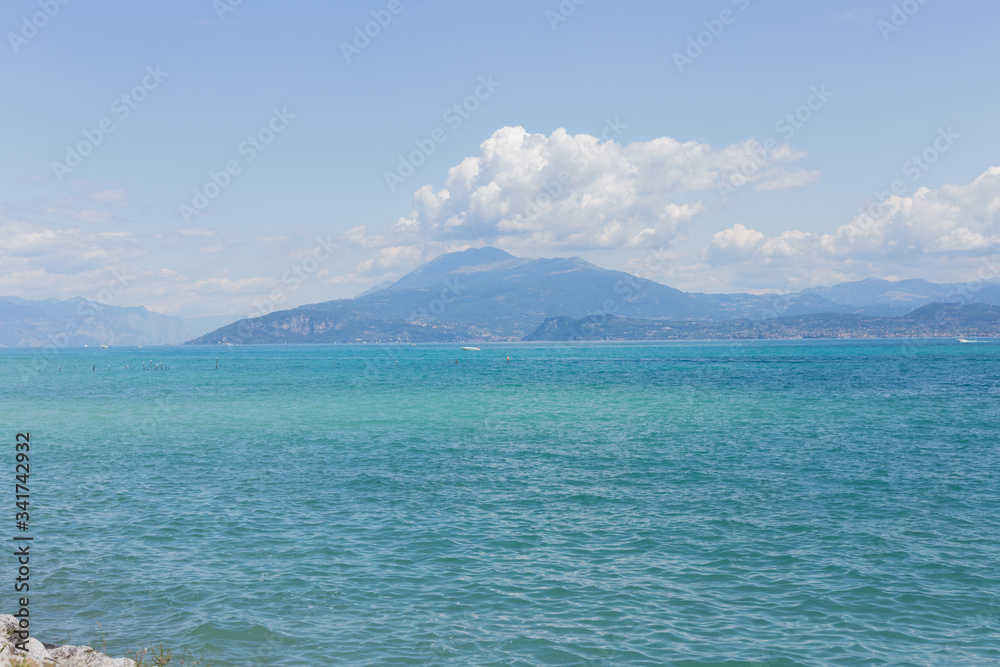 View of Lake Garda in Italy. Daytime. Calmness. Nobody. Nature. Panoramic view. Blue clear water. Landscape. 