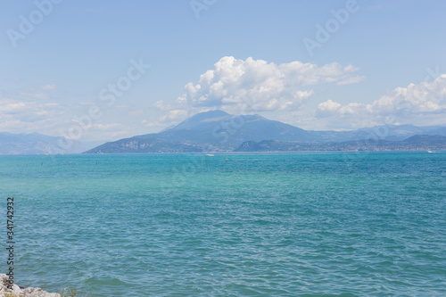View of Lake Garda in Italy. Daytime. Calmness. Nobody. Nature. Panoramic view. Blue clear water. Landscape. 