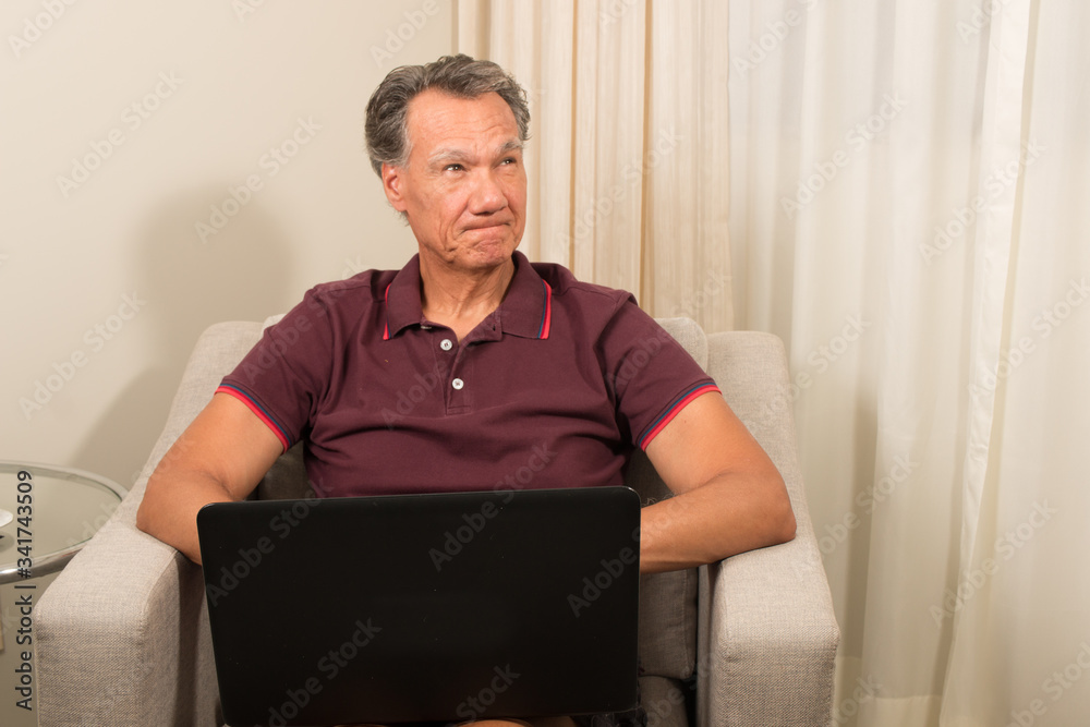 Man working from home on his laptop computer Man working from home on his laptop computer