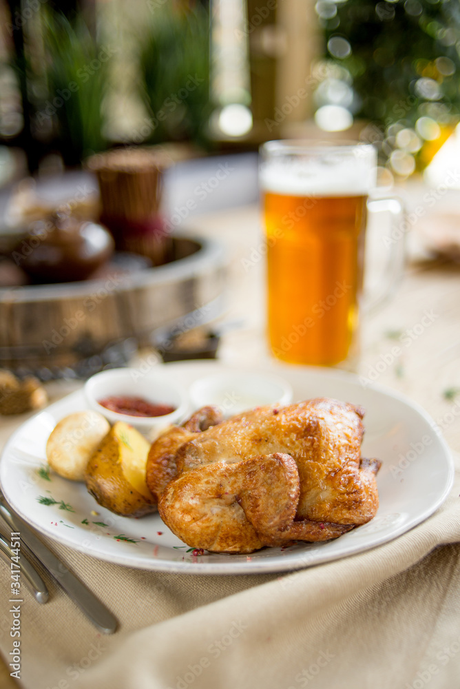 Grilled chick with potato and sauce on cafe restaurant table on terrace bokeh Grilled chick with potato and sauce on cafe restaurant table on terrace bokeh