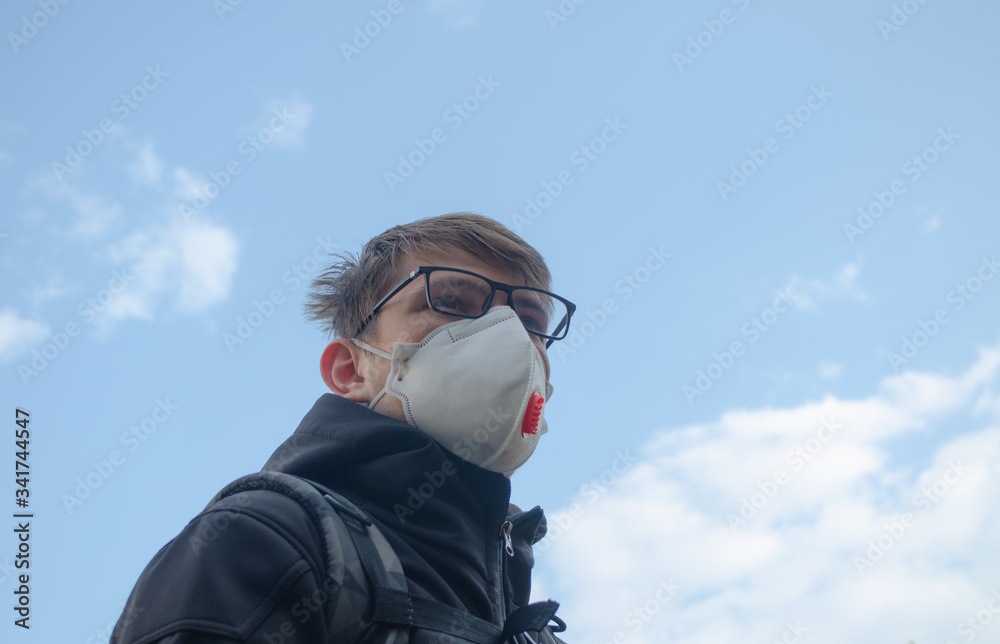 Man with n95 mask agaist blue sky 