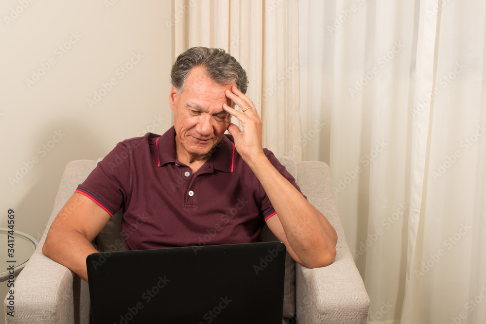 Man working from home on his laptop computer Man working from home on his laptop computer