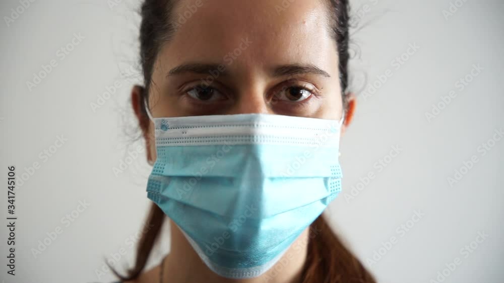 Portrait of a beautiful young woman with a medical mask of protection from the Coronavirus, Covid-19 - Millennial protects herself from the infection by wearing personal protection tools Portrait of a beautiful young woman with a medical mask of protection from the Coronavirus, Covid-19 - Millennial protects herself from the infection by wearing personal protection tools