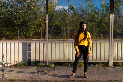 Young black woman posing at abandon tram station, Zagreb, Croatia.