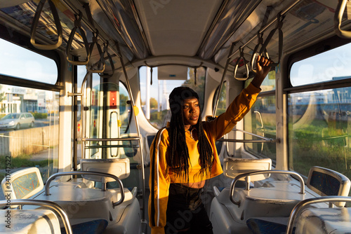 Portrait of young black woman with dreadlocks at public tram, Zagreb, Croatia.