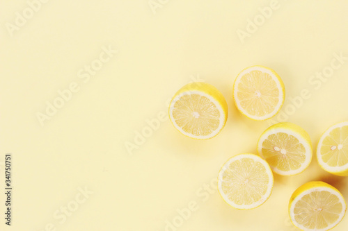 Lemons cut in a half in a yellow background 