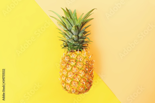 Yellow background with a pineapple in the center