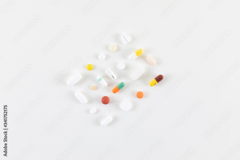 pills and capsules laid out on a white background pills and capsules laid out on a white background