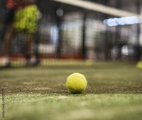 paddle tennis ball in court. Defocused man in background training © FotoAndalucia