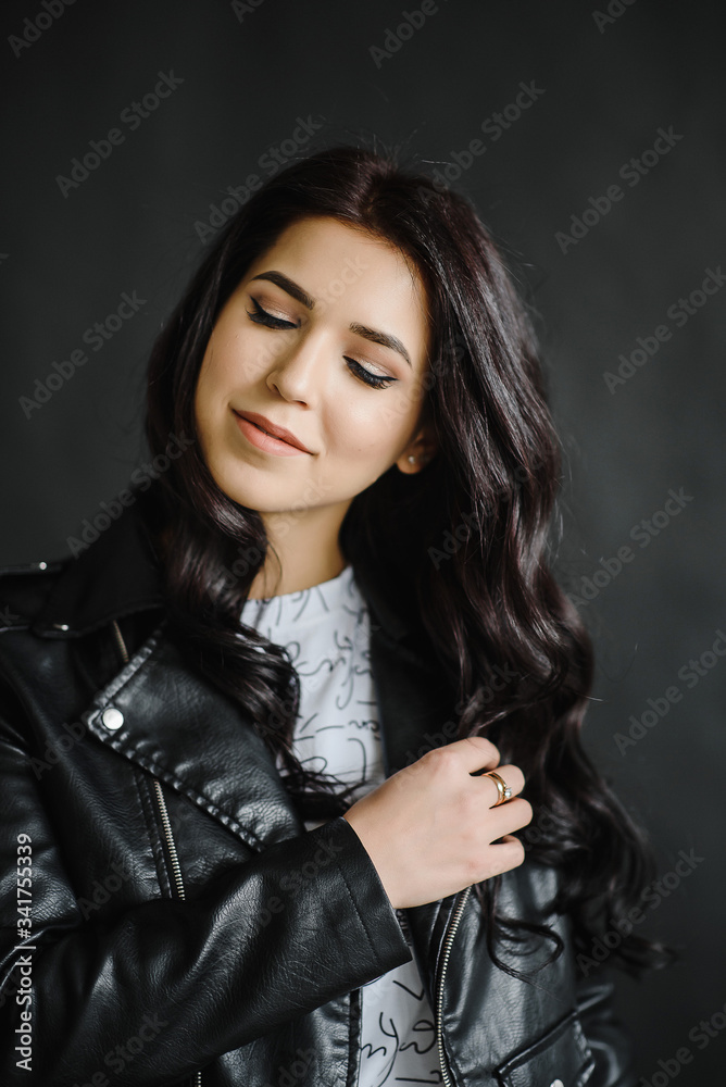 Photo of smiling brunette business woman on black background, Charming sweet girl. Photography of a young cute girl