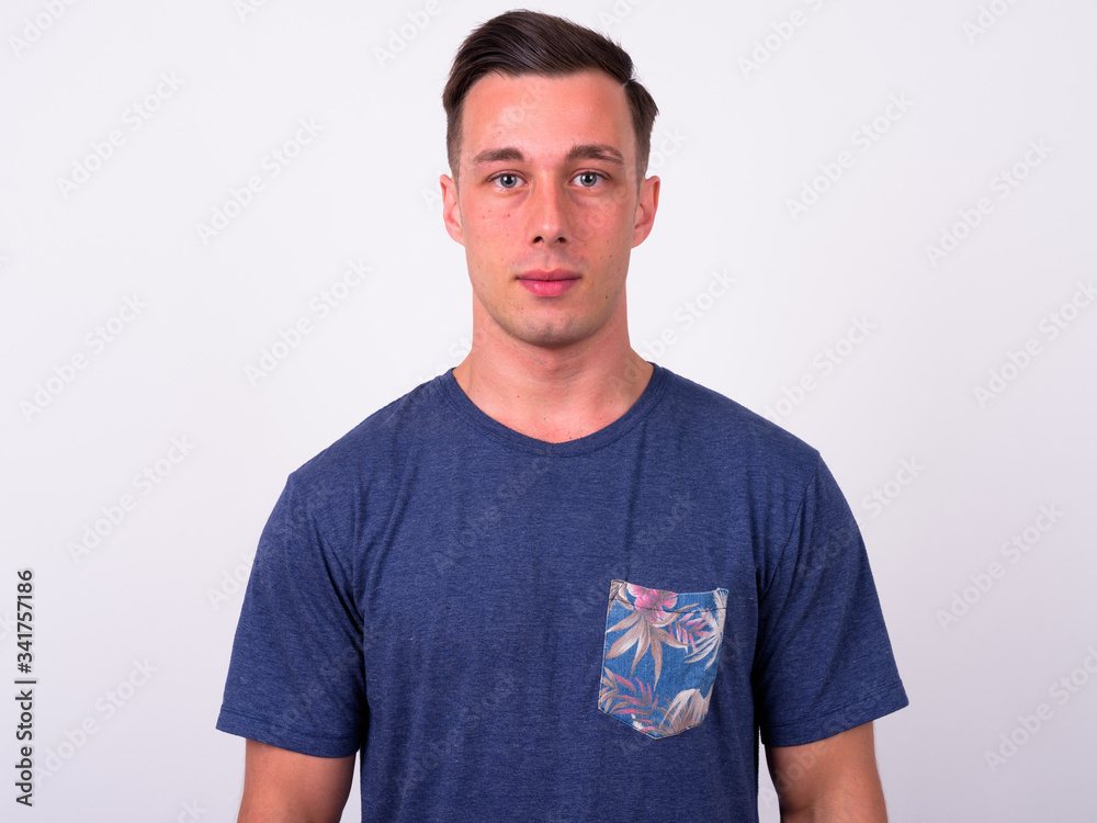 Fototapeta premium Portrait of young handsome man looking at camera