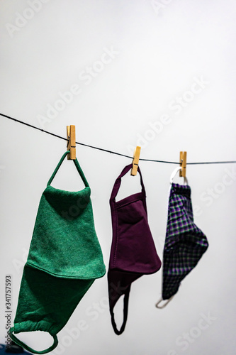 Washable face masks hanging after washing. Washable face masks to help reuse and to protect from being infected with corona covid-19 virus and other illnesses