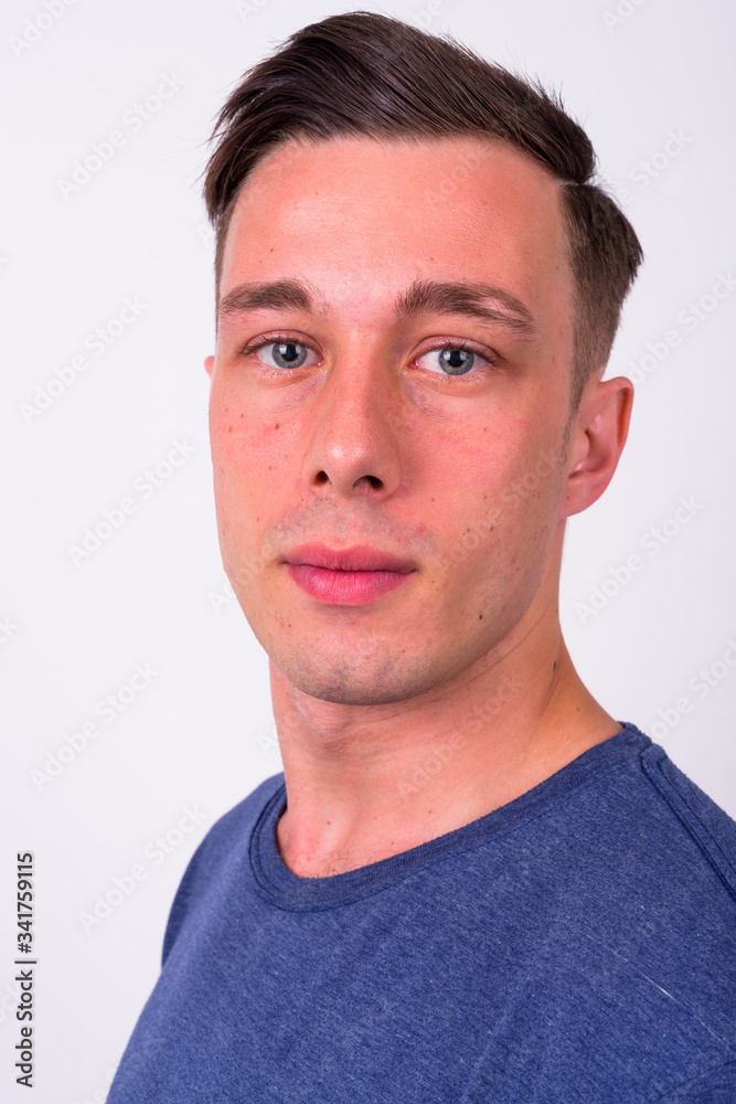 Closeup profile view of young handsome man looking at camera Closeup profile view of young handsome man looking at camera