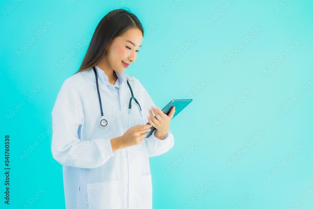 Portrait beautiful young asian doctor woman with stethoscope and smart tablet Portrait beautiful young asian doctor woman with stethoscope and smart tablet