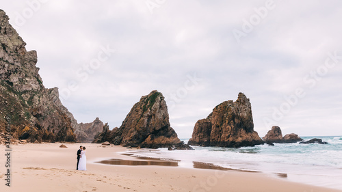 high stone cliffs and sandy coast of the ocean. the bride and gr