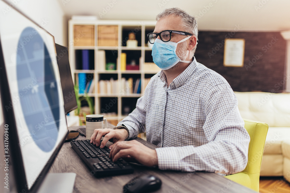 Business man working from home, wear a protective mask. Quarantine due coronavirus pandemic. Stay at home. Business man working from home, wear a protective mask. Quarantine due coronavirus pandemic. Stay at home.